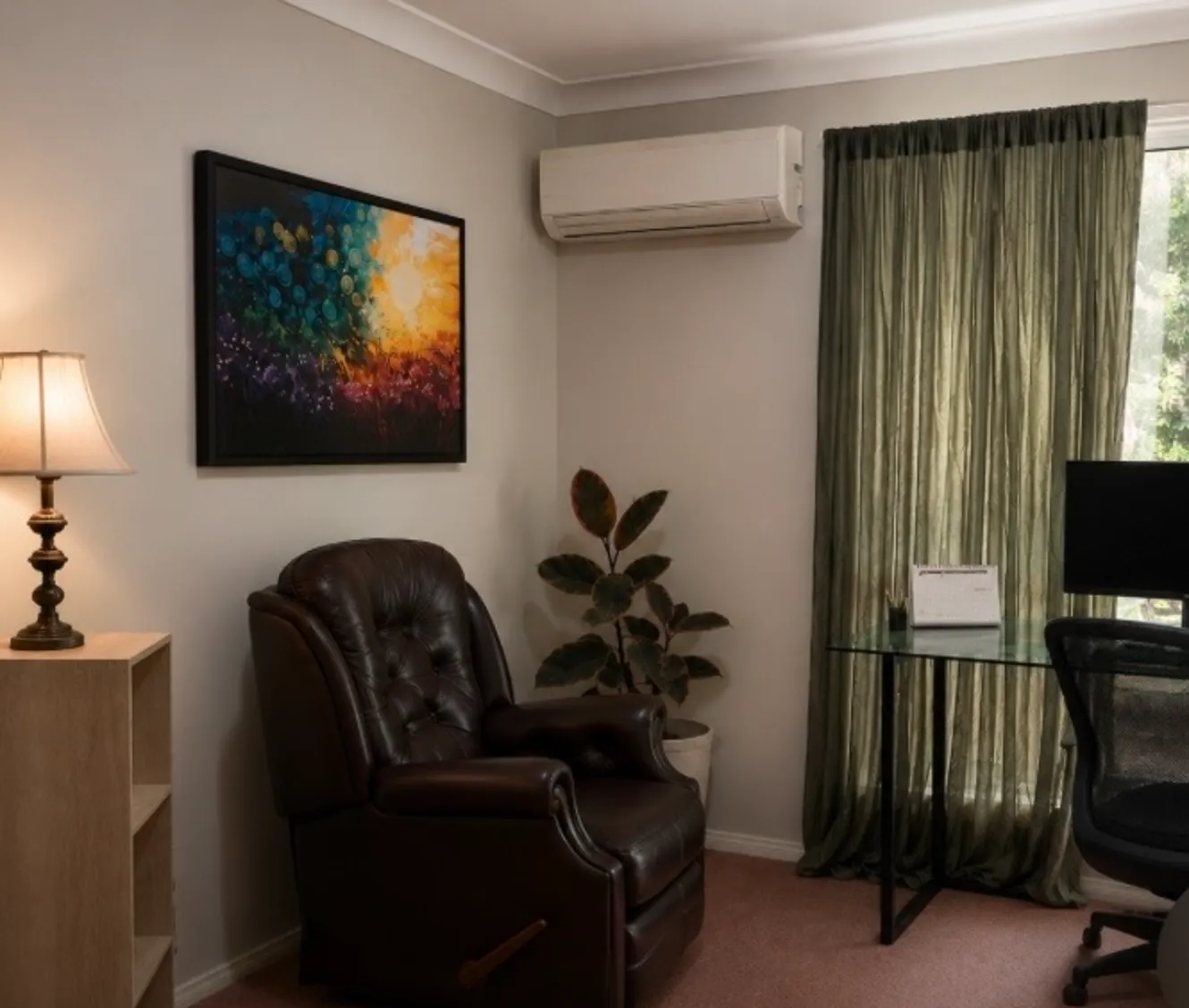 Tayne's therapy room, with the leather chair and bush views through the window